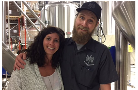 clayton and kari stenson standing in the brewery